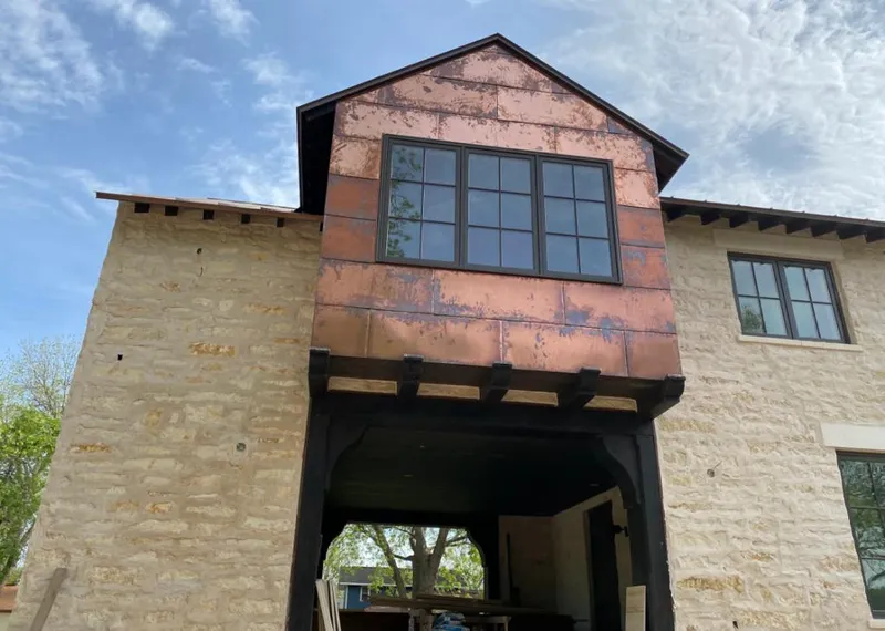 Copper metal panel facade on a stone building for Skylight Installation in Forest Glen